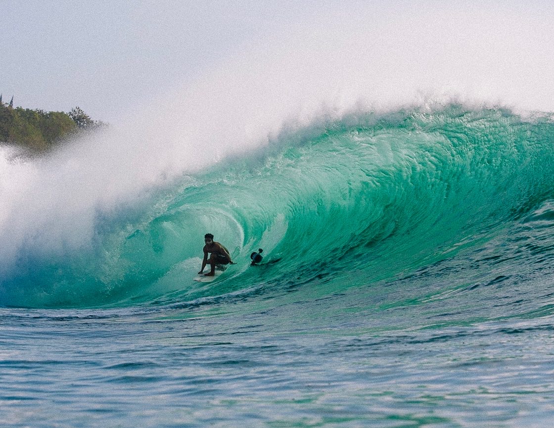 Surf Coach Lempog Jackson surfing a barrel wave at Padang-Padang Beach, Bali